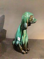 Front-right view of green and black ceramic dog figurine