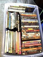 Bin containing entire assortment of DVD cases, spines visible