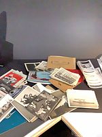 Top view of mixed photographs, postcards and brochures spread on table