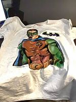 Front view of T-shirt laid flat displaying full Robin graphic and Batman Forever logo