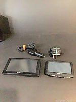 Both GPS units with their respective chargers