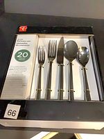Front view of unopened PC 20-piece flatware set box showing five sample utensils