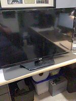 Front view of RCA flat-screen TV on stand