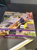 Front of sealed RotoMatic rotary tool kit box showing product image and list of 60 pieces