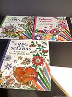 Front covers of three colouring books