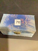 Closed blue brocade box with clasp