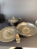 Group view of sugar bowl, tray with ballerina, scalloped bowl and shaker
