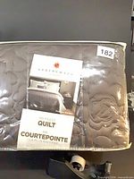 Front view of packaged Springmaid quilt showing brand label and quilting texture