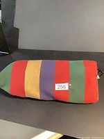 Folded hammock showing multicolor striped fabric