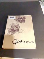Front cover of tan hardcover box with Gollum sketches and title