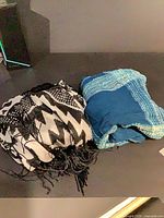 Both shawls folded side by side on surface