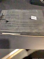 Front of black photo album stamped Photograph