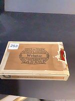 Closed cigar box top showing Webster Flor Superior Habana label