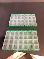 Two weekly pill organizers side by side showing compartments