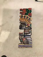 Full view of carved wooden Aztec figure wall hanging