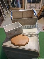Group shot showing woven basket, wooden box, plaque, plastic basket