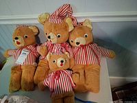 All four bears arranged together showing size differences and outfits