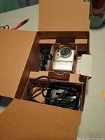 Camera and accessories in cardboard insert