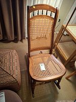 Front view of wood cane rocking chair