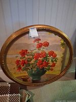 Front view of oval floral artwork and frame