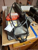 Top view of benchtop jointer-planer showing table, fence, red blade guard and power cord