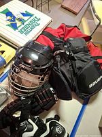 Helmet, gloves, shorts visible on table