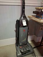 Full view of Hoover WindTunnel upright vacuum cleaner showing hose, body, and control panel