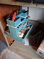 Full view of caddy on shelf with tools inside