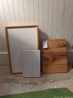 Three trays leaning against wall showing size and surfaces