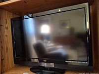 Front view of Vizio TV on shelf