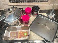 Group shot of pressure cooker, loaf pan, pancake griddle, Reduce jars, Thermos jar