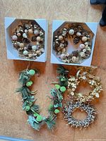 Overview of all wreaths and garland on wooden surface
