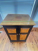 Full view of cabinet front, showing burl panels and overall design