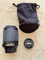 Lens, front cap, pouch overall view