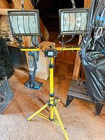 Full view of yellow tripod work light with dual heads