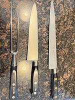 Full view of carving fork, chef knife, slicing knife