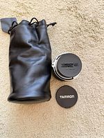 Lens with rear cap, front cap and pouch overview