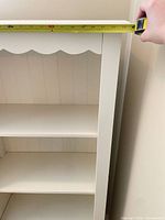 Front view showing shelves and scalloped apron