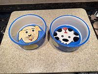 Top view of both bowls showing interiors with dog faces