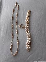 Group shot showing necklace, bracelet and earrings layout