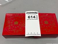 red outer box with Chinese zodiac graphics and lot tag visible