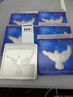 Five souvenir stamp sheets and metal tin shown together