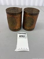 Both hammered copper cups side by side showing overall form and finish