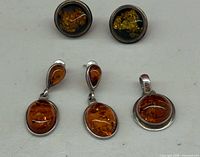 Group of pendant, drop earrings and round stud earrings showing fronts