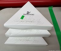 Stack of three triangular Swarovski Christmas Ornament 2001 boxes
