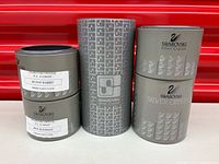 Four Swarovski Silver Crystal cylindrical boxes showing labels for Bunny Rabbit and Mini Elephant