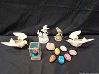 Group shot of all bird figurines, glass birdcage box and stone eggs