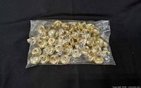 sealed plastic bag filled with metal knobs