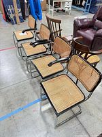 Four black framed Cesca cane chairs on chrome cantilever bases