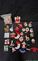 Complete lot overview showing bag of rings and 24 plastic canvas ornaments